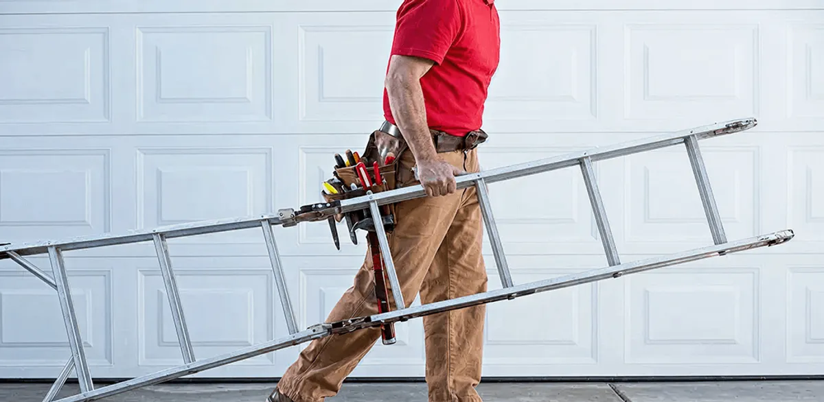 Garage door repair technician arriving with tools and ladder in Sarasota, FL