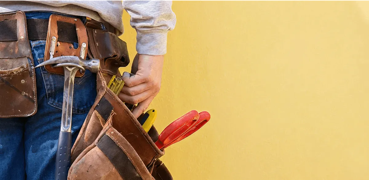 Handyman with tool belt ready for home repairs and maintenance in Sarasota, FL