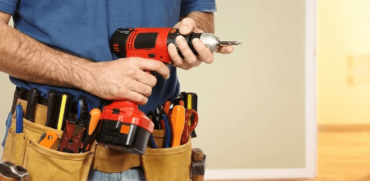 Handyman holding a power drill for home repairs and installations in Sarasota, FL